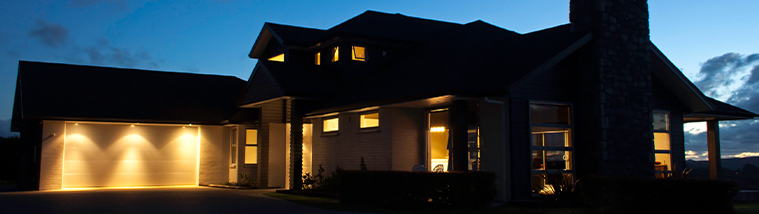 Exterior of residential home at night with lights on